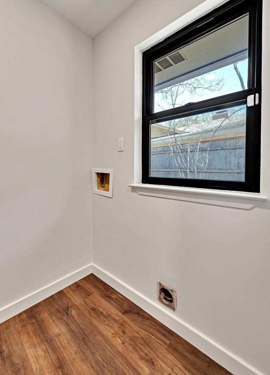 clothes washing area with baseboards, washer hookup, dark wood-style floors, and laundry area