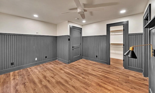 unfurnished room featuring recessed lighting, light wood-style floors, a wainscoted wall, and ceiling fan