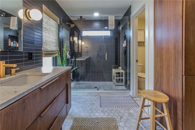 full bath featuring toilet, backsplash, a shower stall, tile patterned flooring, and vanity