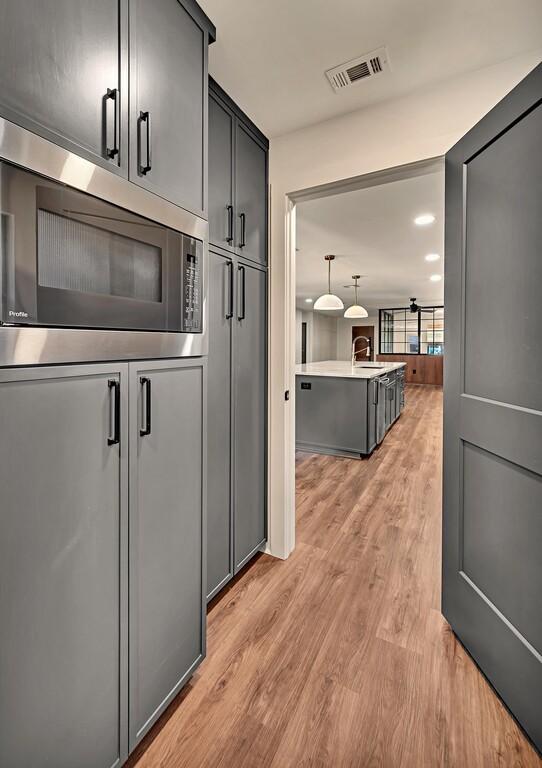 interior space with visible vents, light wood finished floors, and a sink