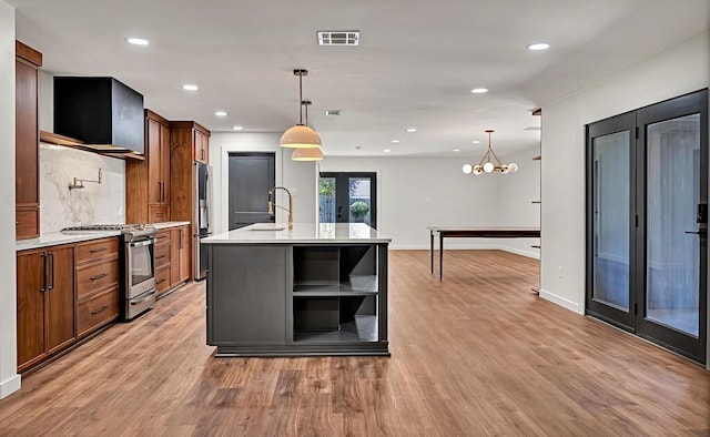 kitchen featuring visible vents, stainless steel appliances, light countertops, and open shelves