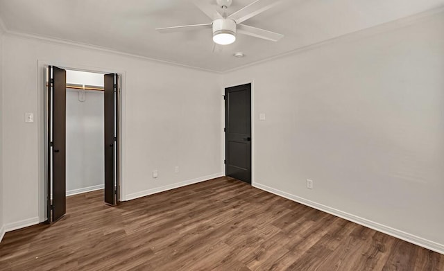 unfurnished bedroom featuring baseboards, wood finished floors, a closet, and ornamental molding