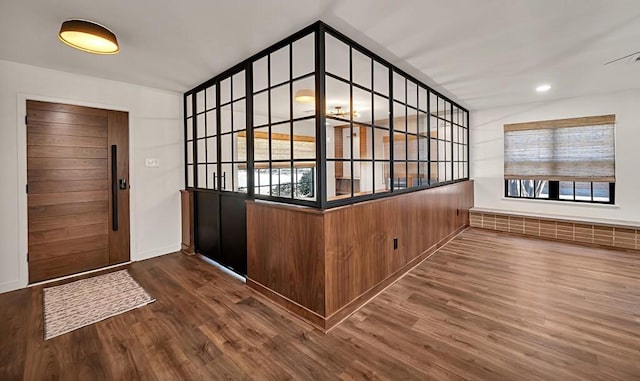 entryway featuring recessed lighting, a healthy amount of sunlight, and wood finished floors