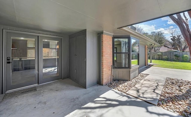 entrance to property featuring a patio area and fence