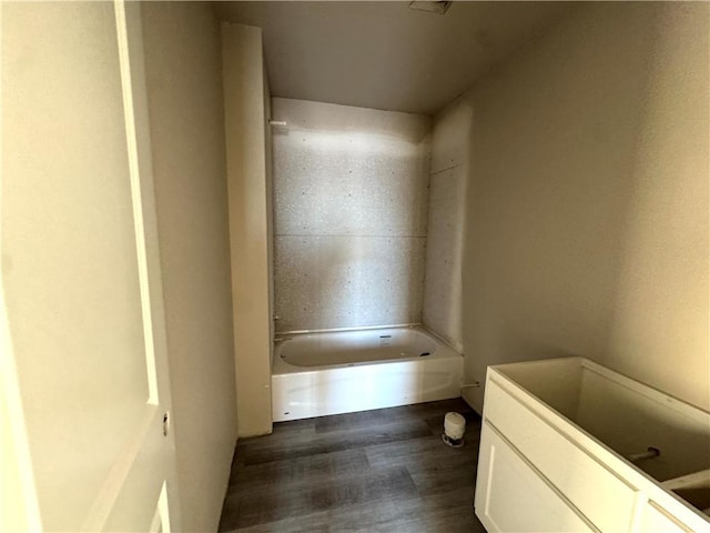 bathroom featuring hardwood / wood-style flooring and a tub