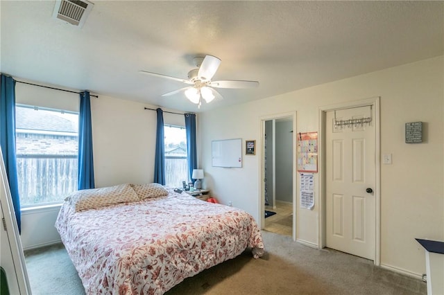 bedroom featuring light carpet and ceiling fan