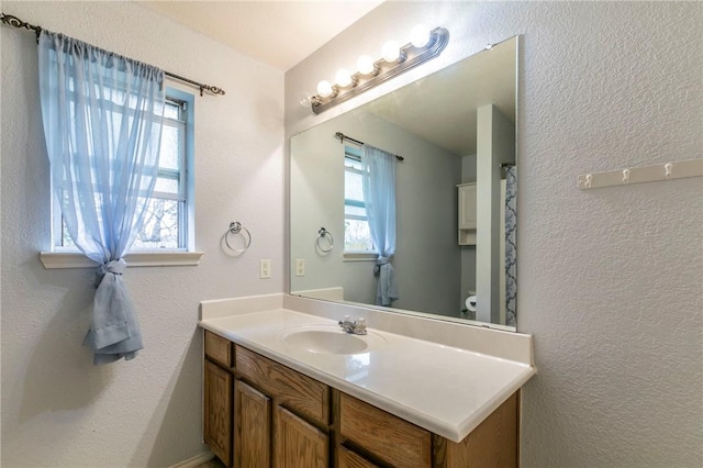 bathroom featuring vanity and toilet