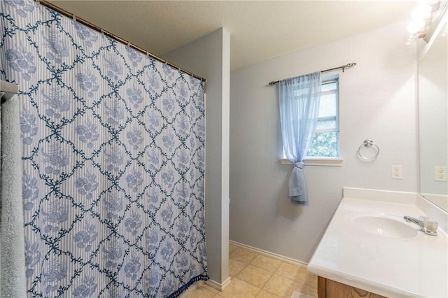 bathroom with curtained shower and vanity