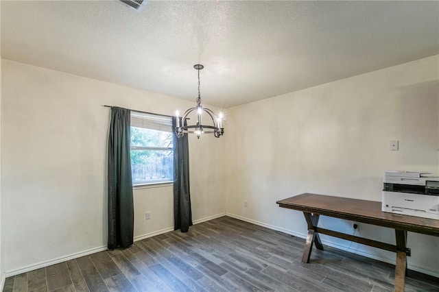 unfurnished dining area with dark hardwood / wood-style floors and an inviting chandelier