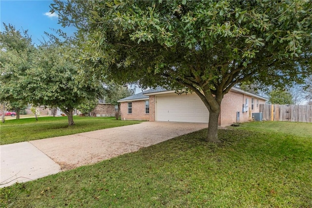 view of front of home with cooling unit, a front yard, and a garage