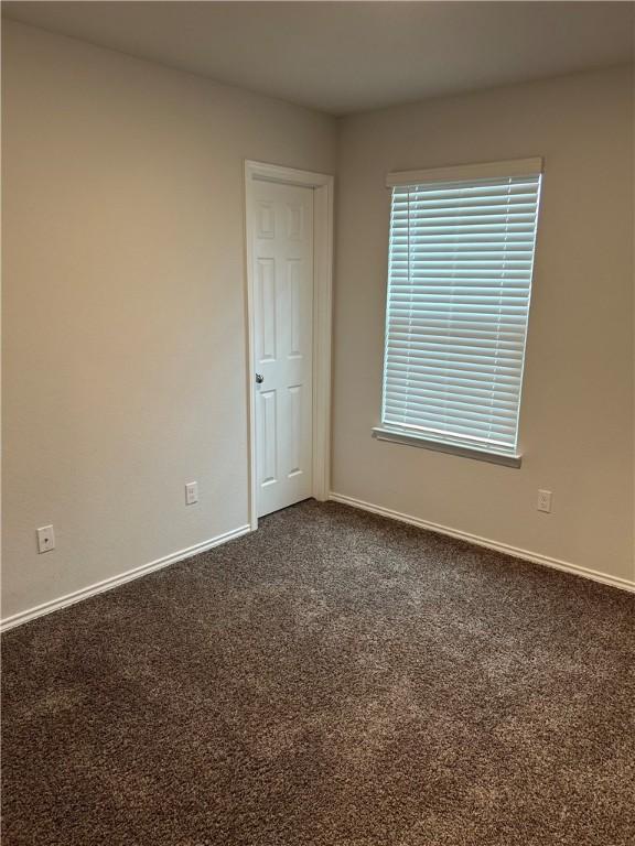 unfurnished room featuring carpet flooring