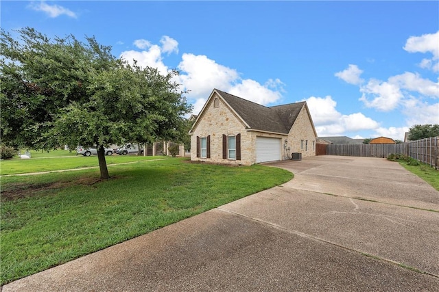 view of side of home featuring a lawn and a garage