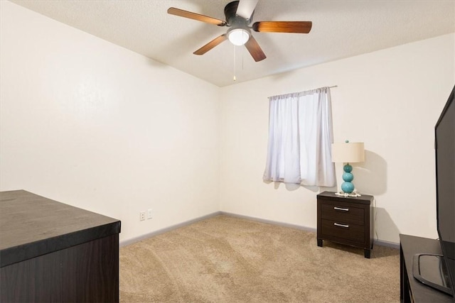 carpeted bedroom featuring a textured ceiling and ceiling fan