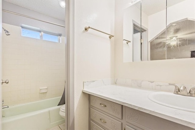 full bathroom with vanity, shower / bath combo, toilet, and a textured ceiling