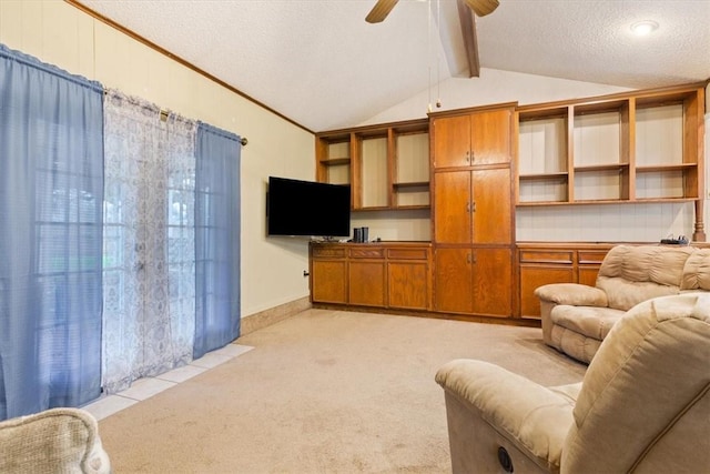 living room with ceiling fan, vaulted ceiling with beams, light colored carpet, and a textured ceiling