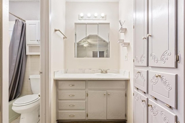 full bathroom with vanity, shower / tub combo, and toilet