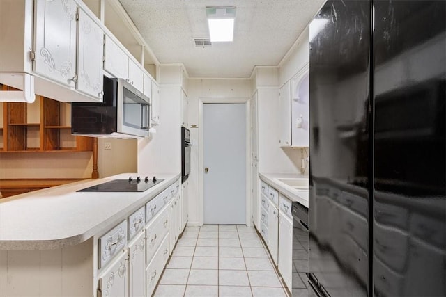 kitchen featuring light tile patterned flooring, white cabinetry, a textured ceiling, kitchen peninsula, and black appliances