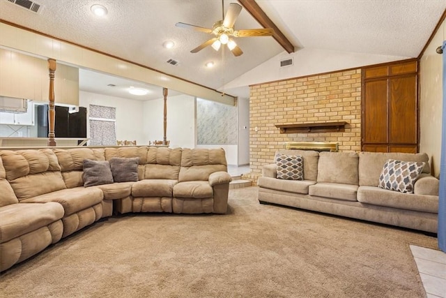 living room featuring a fireplace, vaulted ceiling with beams, ceiling fan, light carpet, and a textured ceiling