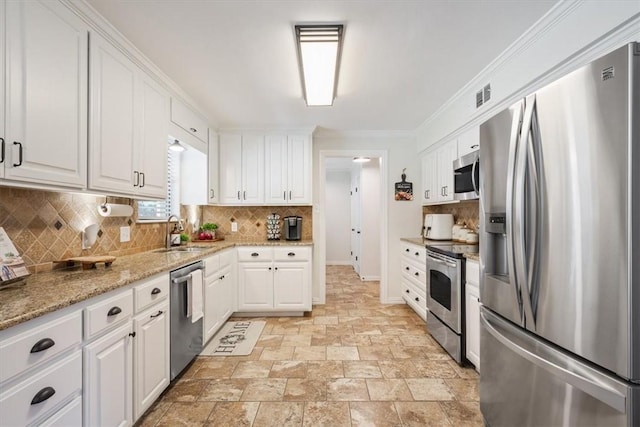 kitchen featuring white cabinetry, sink, stainless steel appliances, backsplash, and ornamental molding