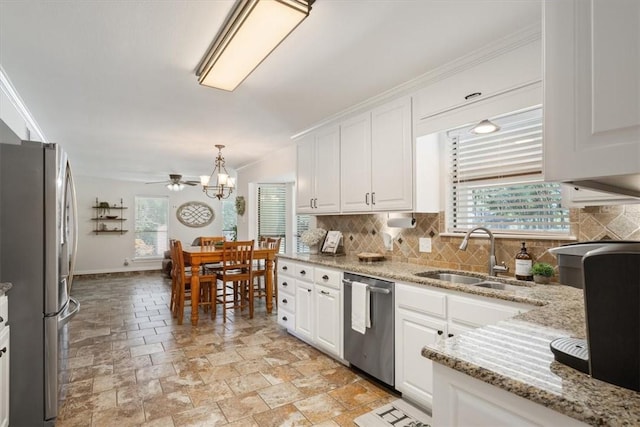 kitchen with tasteful backsplash, white cabinetry, sink, and stainless steel appliances