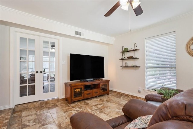 living room featuring plenty of natural light, crown molding, and french doors