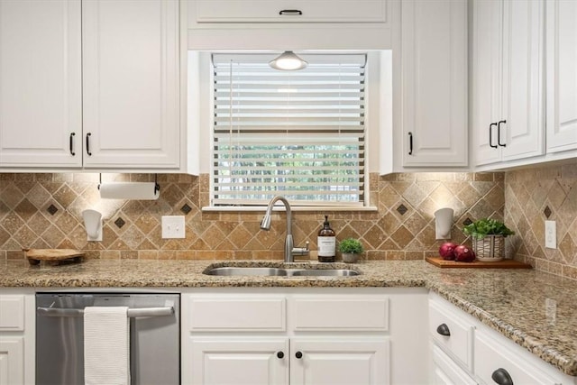 kitchen with decorative backsplash, white cabinetry, dishwasher, and sink