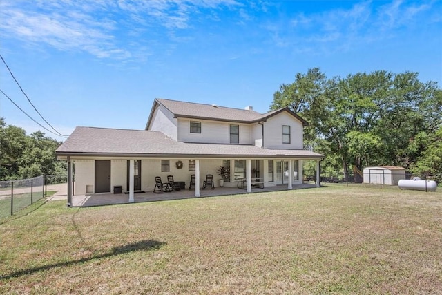 rear view of house featuring a yard and a patio