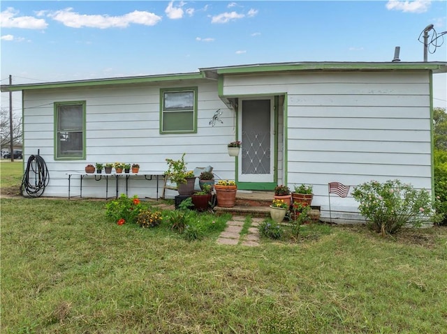 rear view of house with a lawn