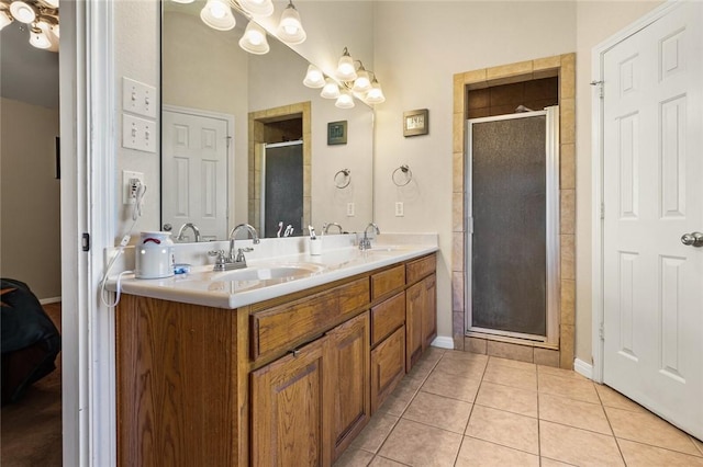 bathroom with tile patterned flooring, vanity, an enclosed shower, and an inviting chandelier