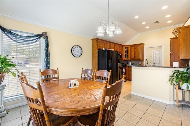 dining room featuring a wealth of natural light, light tile patterned flooring, a chandelier, and vaulted ceiling