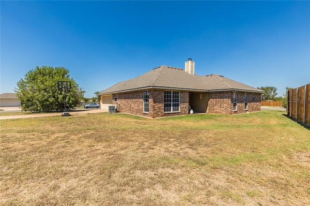 rear view of property featuring a lawn