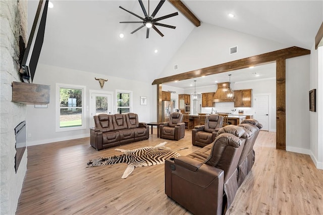 living room featuring ceiling fan, light hardwood / wood-style floors, beam ceiling, and high vaulted ceiling