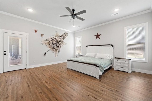 bedroom with ceiling fan, crown molding, and wood-type flooring