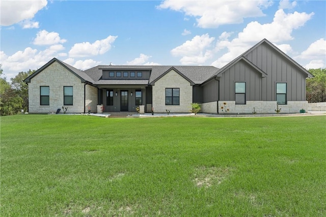 back of property featuring a lawn