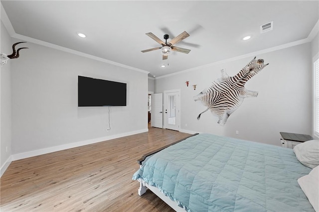 bedroom with ceiling fan, ornamental molding, and light hardwood / wood-style flooring