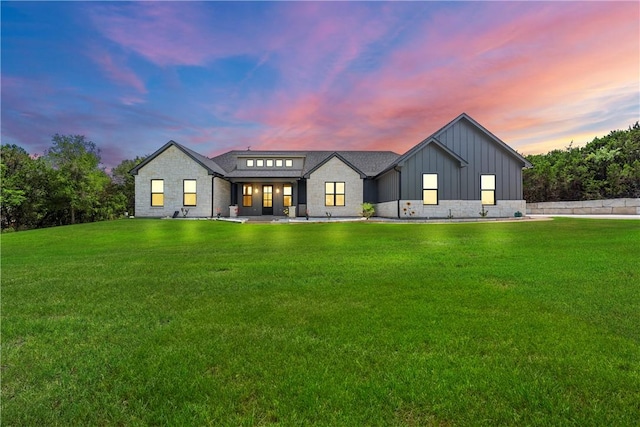 view of front of home with a yard