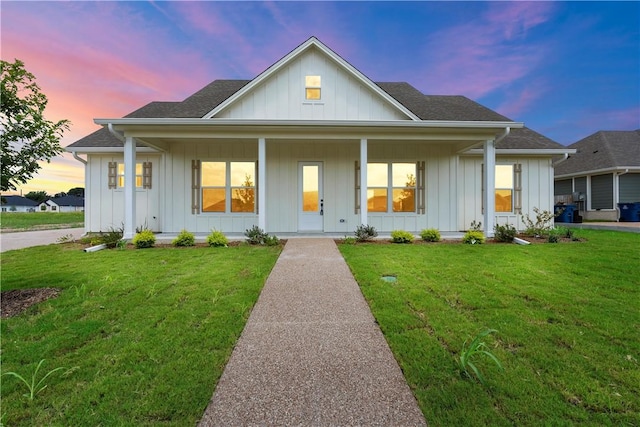 modern farmhouse style home with a lawn