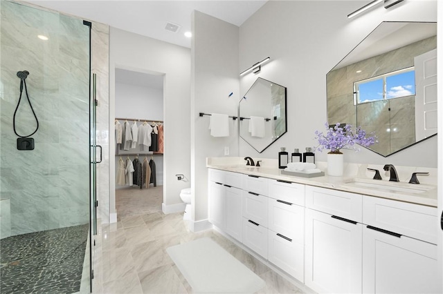 bathroom featuring vanity, toilet, and an enclosed shower