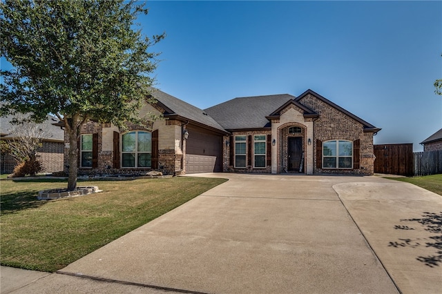 view of front of home with a front lawn and a garage