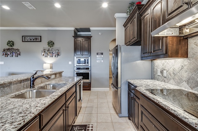 kitchen with crown molding, dark brown cabinetry, sink, and appliances with stainless steel finishes