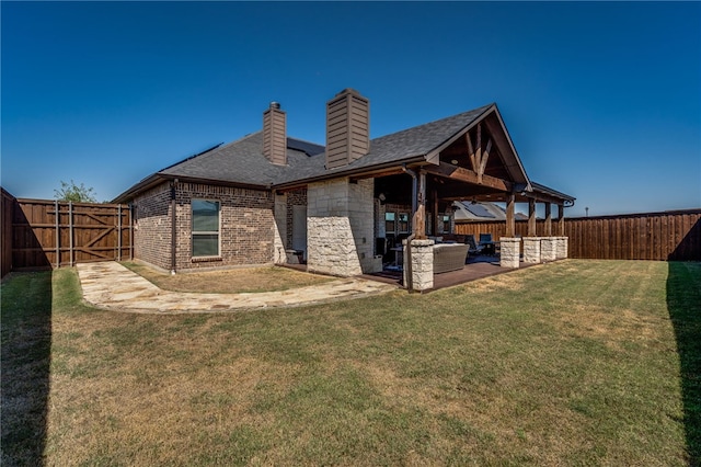 rear view of property with a lawn, area for grilling, and a patio