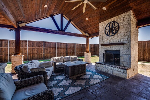 view of patio / terrace featuring an outdoor living space with a fireplace and ceiling fan