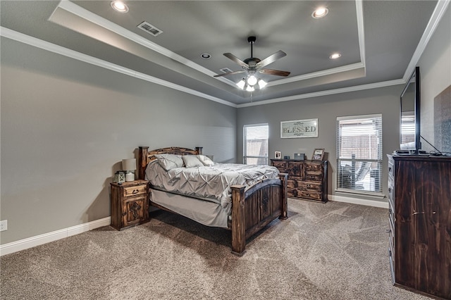 bedroom with a tray ceiling, ceiling fan, carpet floors, and ornamental molding