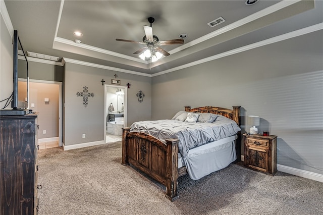 bedroom with ensuite bathroom, a raised ceiling, crown molding, ceiling fan, and carpet floors