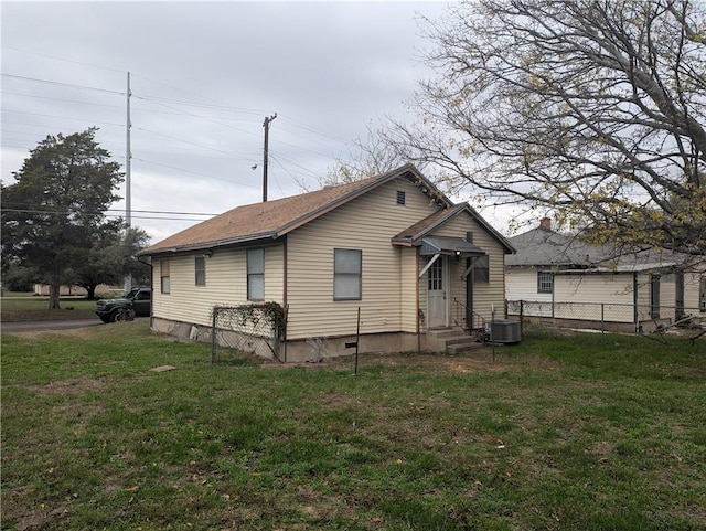 back of house featuring a lawn and central AC unit