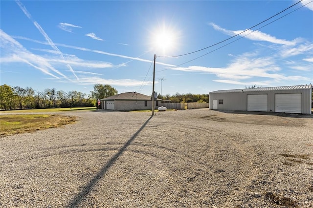 view of yard featuring a garage and an outbuilding