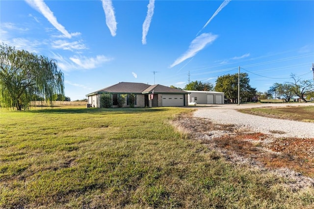 ranch-style house featuring a front lawn and a garage