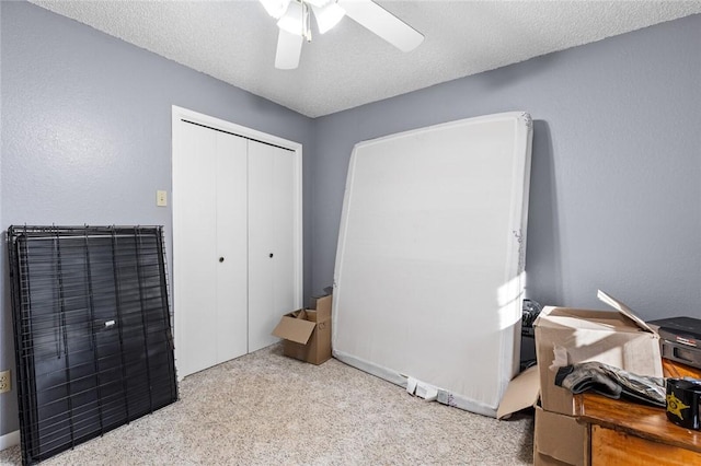 office area featuring light carpet, a textured ceiling, and ceiling fan