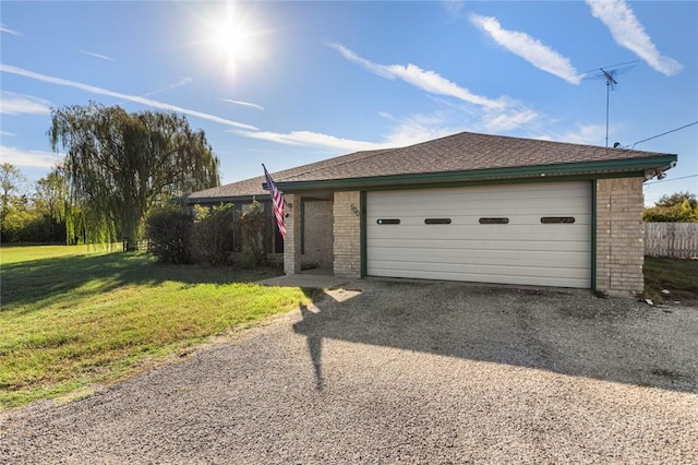 view of front facade with an outbuilding, a front lawn, and a garage