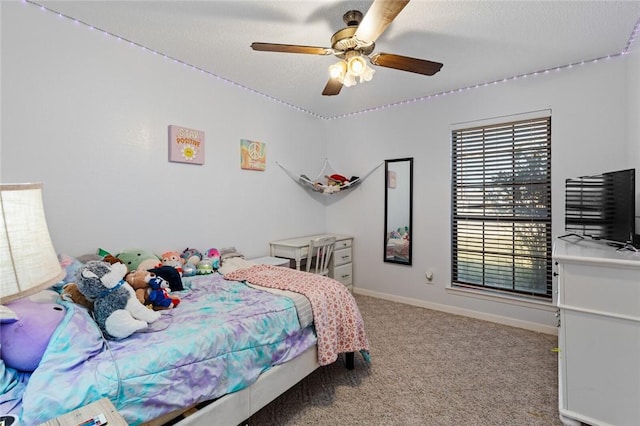 bedroom with ceiling fan and light carpet